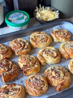 several different types of pastries on a baking sheet next to some other food items