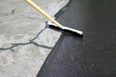 a broom is laying on the pavement with it's handle extended