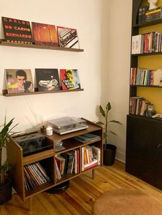 there is a record player on the shelf in this living room