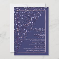 an elegant purple and gold wedding card with confetti on the border, in front of a marble background