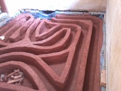 the floor is being worked on with bricks and mortars to make it look like an intricate maze