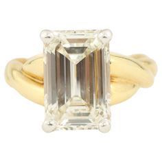 Modern diamond 18 karat yellow gold engagement ring available from Bracken Jewelers in Venice, California. Featuring a 3.09 carat emerald cut diamond (11.4x7.5x4.45mm, clarity VS-1, color K-L) set in platinum prongs with a twisted 18 karat yellow gold band. Venice California, Platinum Engagement Ring, Yellow Gold Engagement Ring, Emerald Cut Diamond, Yellow Gold Engagement, Platinum Engagement Rings, Yellow Gold Engagement Rings, Gold Engagement Ring, Diamond Solitaire Engagement Ring