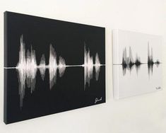 two black and white sound waves are hanging on the wall