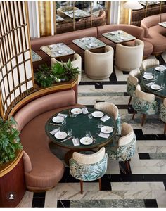 an overhead view of a restaurant with tables, chairs and potted plants on the floor