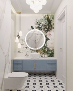 the bathroom is decorated in white and blue with flowers on the wall behind the mirror