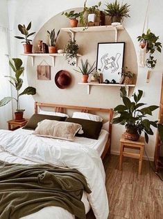 a bedroom with plants on the shelves above the bed and below the bed is a mirror