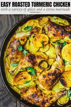 a pan filled with chicken and vegetables on top of a wooden table