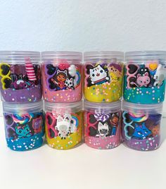 a group of plastic containers filled with lots of different designs and colors on top of each other