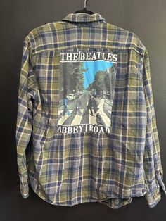 One of a kind, handmade up-cycled BEATLES flannel shirt. Perfectly imperfect! MEN'S LARGE for more specific sizing information reach out and I will measure! Vintage Long Sleeve Graphic Print Flannel Shirt, Long Sleeve Flannel Top With Graphic Print, Vintage Plaid Flannel Shirt With Graphic Print, Vintage Flannel Relaxed Fit Top, Vintage Relaxed Fit Flannel Top, Casual Flannel Shirt With Graphic Print, Vintage Long Sleeve Upcycled Top, Vintage Flannel Top With Relaxed Fit, Casual Long Sleeve Upcycled Tops