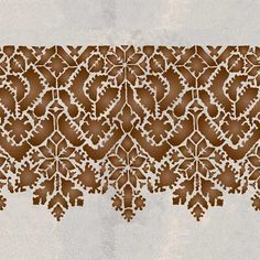 an intricately designed wallpaper with brown and white designs on the top, bottom and bottom