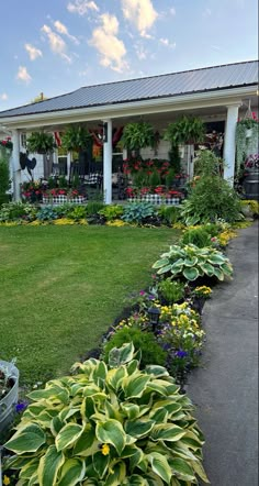 a house with lots of flowers in front of it