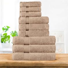 a stack of towels sitting on top of a wooden table