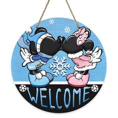 mickey and minnie kissing in front of a welcome sign with snowflakes on it