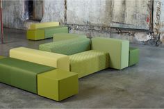 several green and yellow couches in an empty room