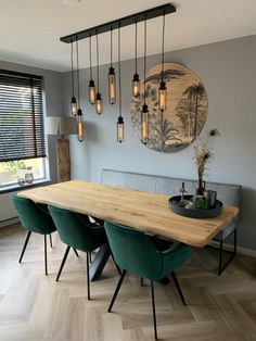 a dining room table with green chairs and hanging lights