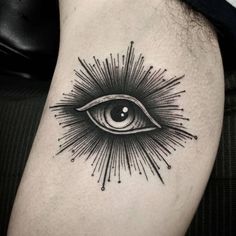 an eye with rays coming out of it on the thigh, and in the middle of the leg