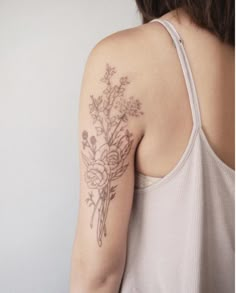 a woman with a flower tattoo on her arm