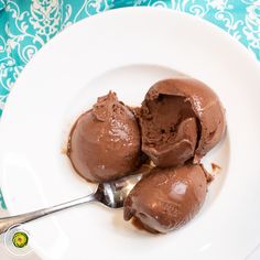 two scoops of chocolate ice cream on a white plate