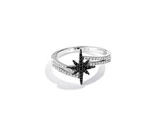 a white gold ring with black and white diamonds in the shape of a starfish