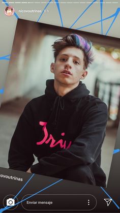 a young man with colorful hair sitting down