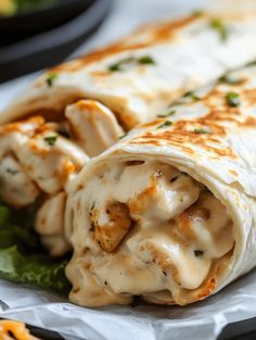 there is a wrap with chicken and cheese on it