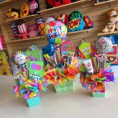 there are many birthday decorations on display in the store, including balloons and candy boxes