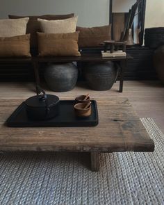 a coffee table with two cups on it