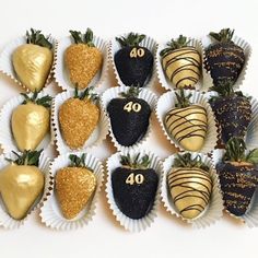 chocolate covered strawberries are arranged in the shape of number forty and decorated with gold leaf