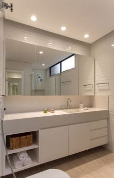 a bathroom with two sinks and a large mirror over it's sink area,