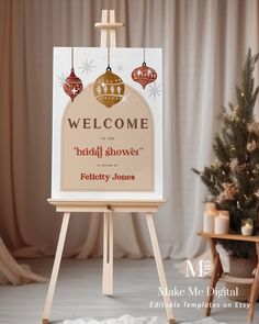 a welcome sign for the bridal shower is displayed in front of a christmas tree