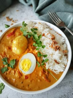 a bowl filled with rice and an egg on top