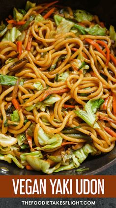 vegan yaki udon with carrots and lettuce in a skillet