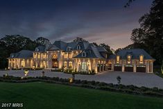 a large house with lots of windows and lights