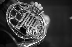 a close up of a french horn in black and white