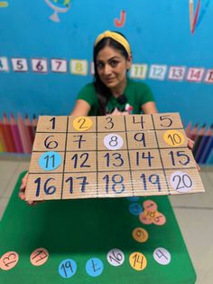 a girl holding up a board with numbers on it