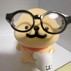 a small toy with glasses and a fake dog