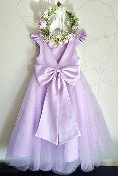 a purple dress hanging on a wall