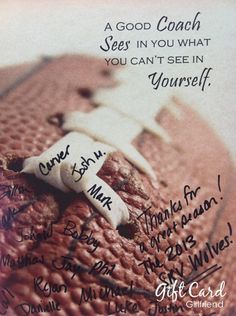 a close up of a football with writing on the side and an image of someone's hand written on it