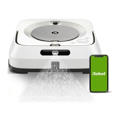 a robot vacuum is connected to a phone with the appliance on it's side