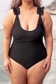 Ruffle some feathers when you show up looking so good in this swimsuit! The solid black color will stop them dead in their tracks and the ruffle straps are so sweet! This cutie has adjustable straps so you can ensure the perfect fit and the one piece style looks great on everyone! Style it with some sandals for a super stylish look! 82% Polyamide, 18% Elasthane Black One-piece Swimwear With Adjustable Straps, Black Swimwear With Knotted Straps For Summer, Fitted Black Swimwear With Knotted Straps, Black Spaghetti Strap Swimwear For Poolside, Black Sleeveless Swimwear With Adjustable Straps, Tie Straps Swimwear For Beach, Solid Color Swimwear With Tie Straps For Beach, One Piece Style, Chic Soul