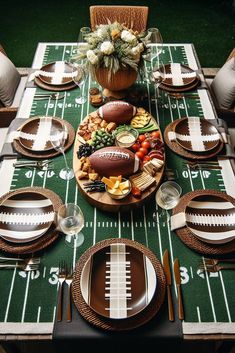 a football themed table setting with plates and silverware