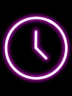 a purple clock is glowing in the dark