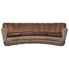 a brown couch sitting on top of a white floor