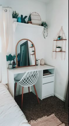 a white desk with a mirror, chair and shelves on it in a room that has carpeted flooring