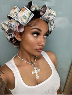 a woman with lots of money on her head wearing a white tank top and necklace