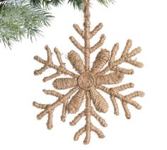 a snowflake ornament hanging from a christmas tree