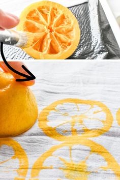 an orange is being peeled and placed on a table cloth with a brush in it