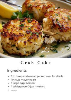 crab cakes on a plate with lemon wedges and parsley garnishes