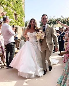 a bride and groom walking down the aisle