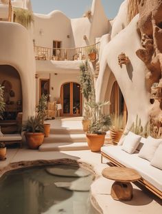 an indoor hot tub surrounded by potted plants